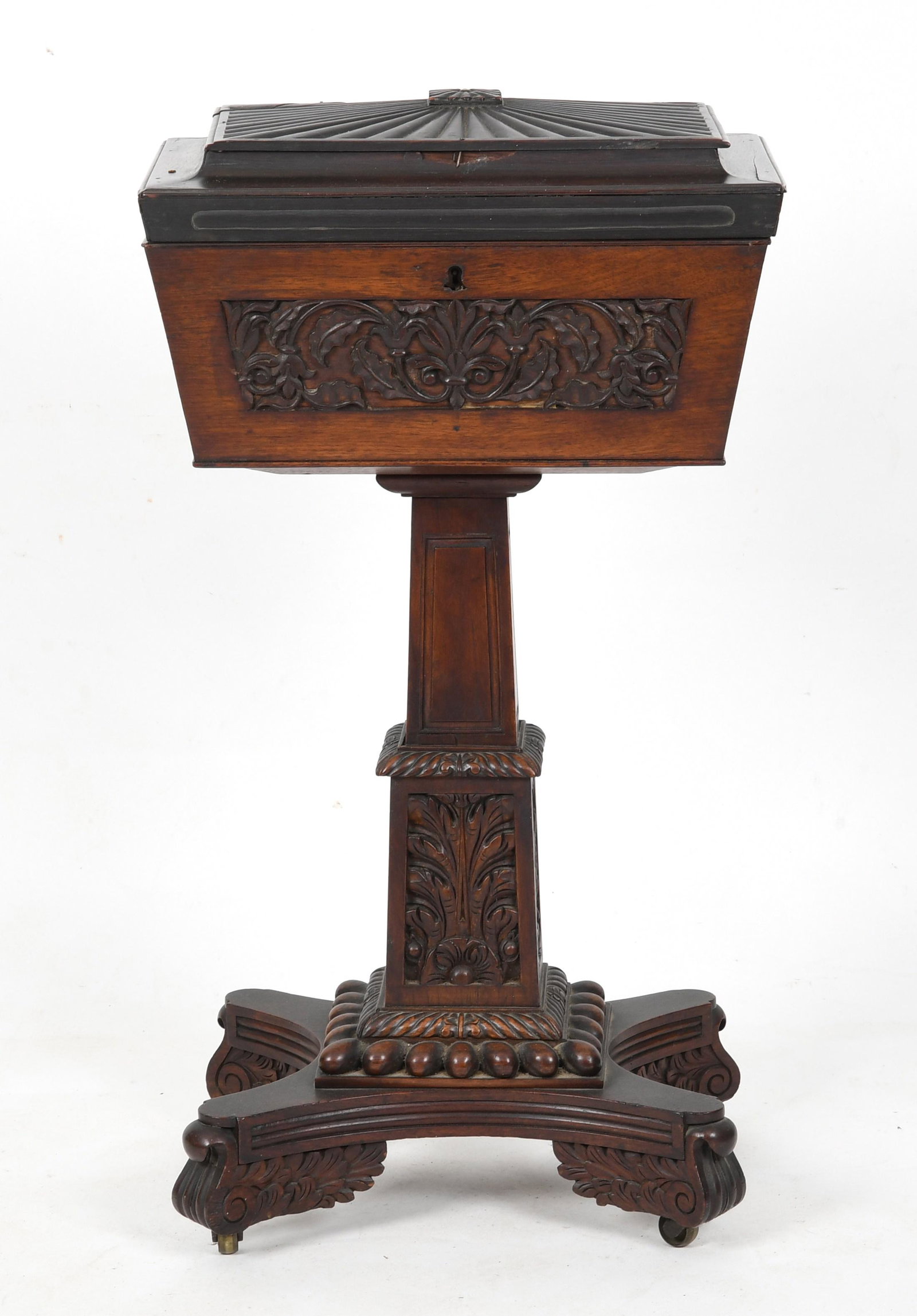 An Anglo-Indian carved rosewood teapoy: An Anglo-Indian carved rosewood teapoy, mid 19th century, the hinged lid to reveal nine open compartments, raised on bass casters Dimensions:height 33 1/2in; width 18 1/2in; depth 12 1/4in. Provenance