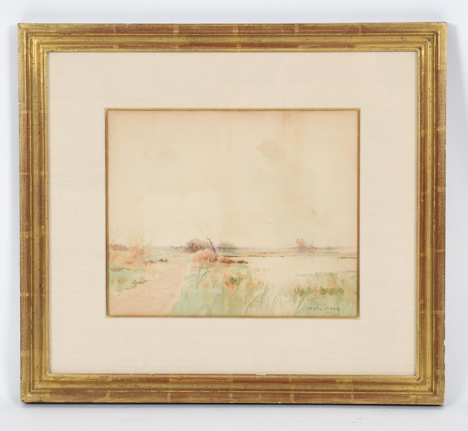 Bruce Crane (1857 - 1937) Watercolor: "Marsh Meadow", signed at the lower right, with gallery tags affixed verso as pictured. Dimensions:Sight is 10 1/2" x 12 1/2", the frame 19 1/4" x 21 3/4". Provenance:From a Main Line Collection.
