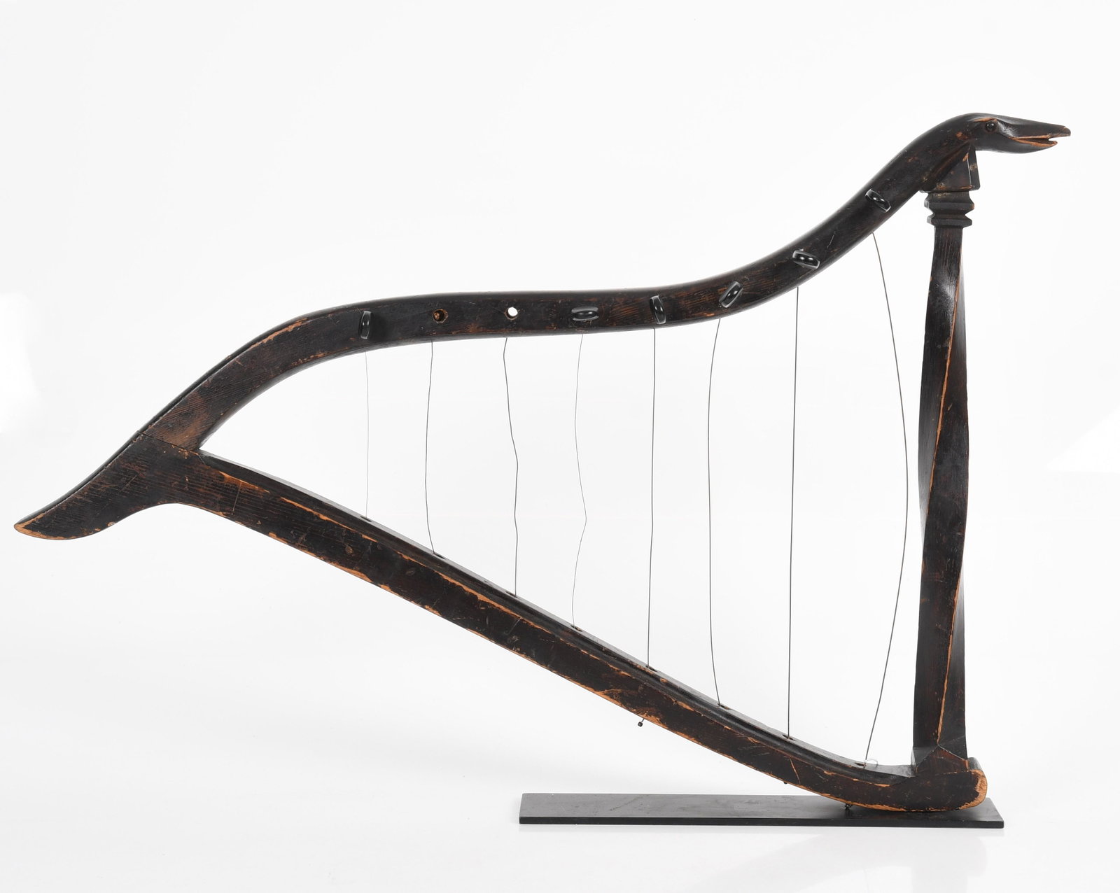A Folk Art Harp: Appears to be from the early 20th century, ebonized soft wood with a snake decorated frame, unmarked. Dimensions:33 1/2" x 23" x 2". Provenance:From the estate of Jack R Bershad