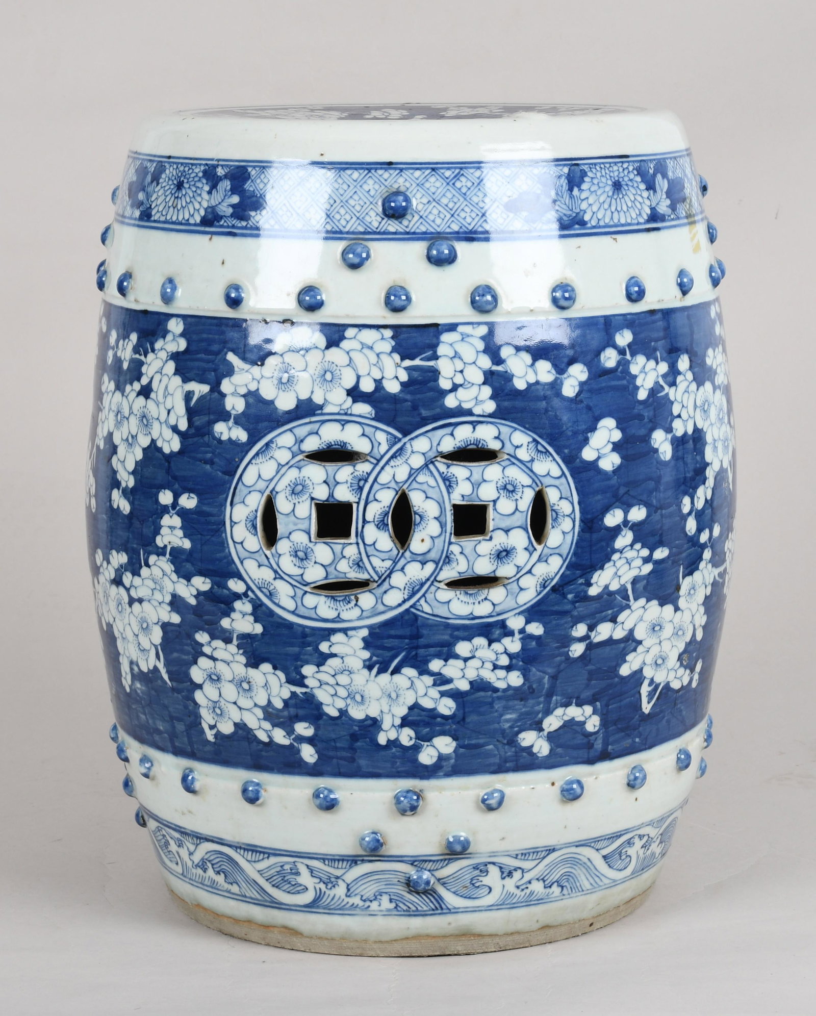 A Chinese Porcelain Blue and White Garden Seat: Late Qing Dynasty, drum form and in the "Hawthorn" pattern. Dimensions:height 18in; diameter of top 12in Provenance:From a Main Line collection.