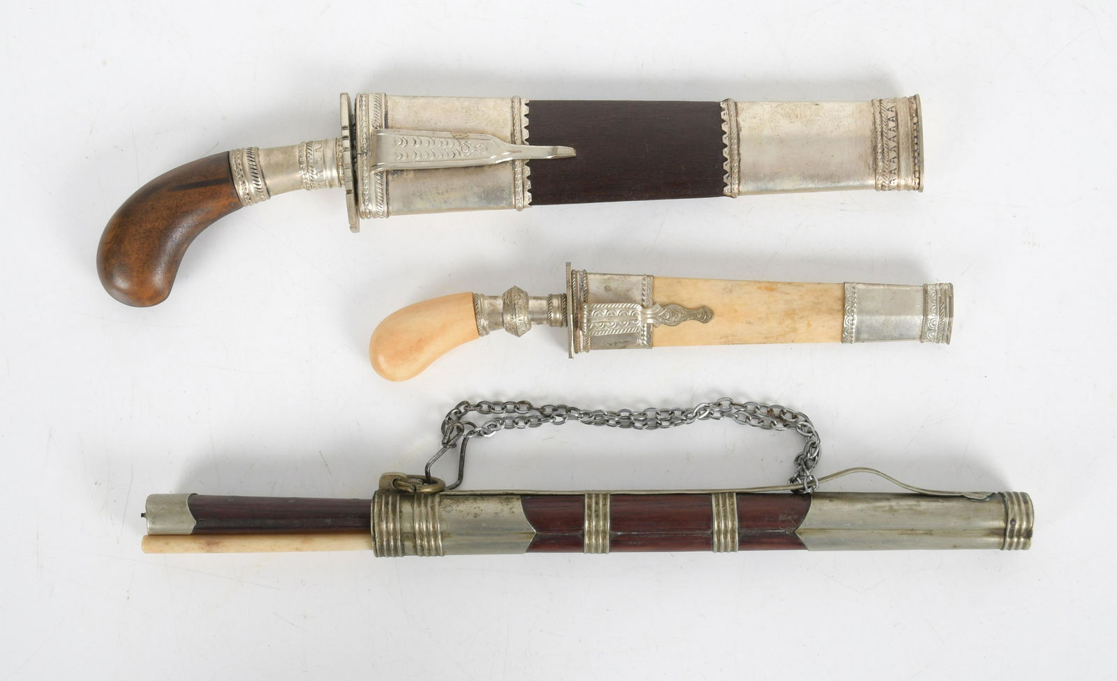 Three Asian Items, Daggers and Food Set: All 20th century, materials include steel, bone and rosewood. Dimensions:From 8" to 12" long. Provenance:From a Bucks County collection.