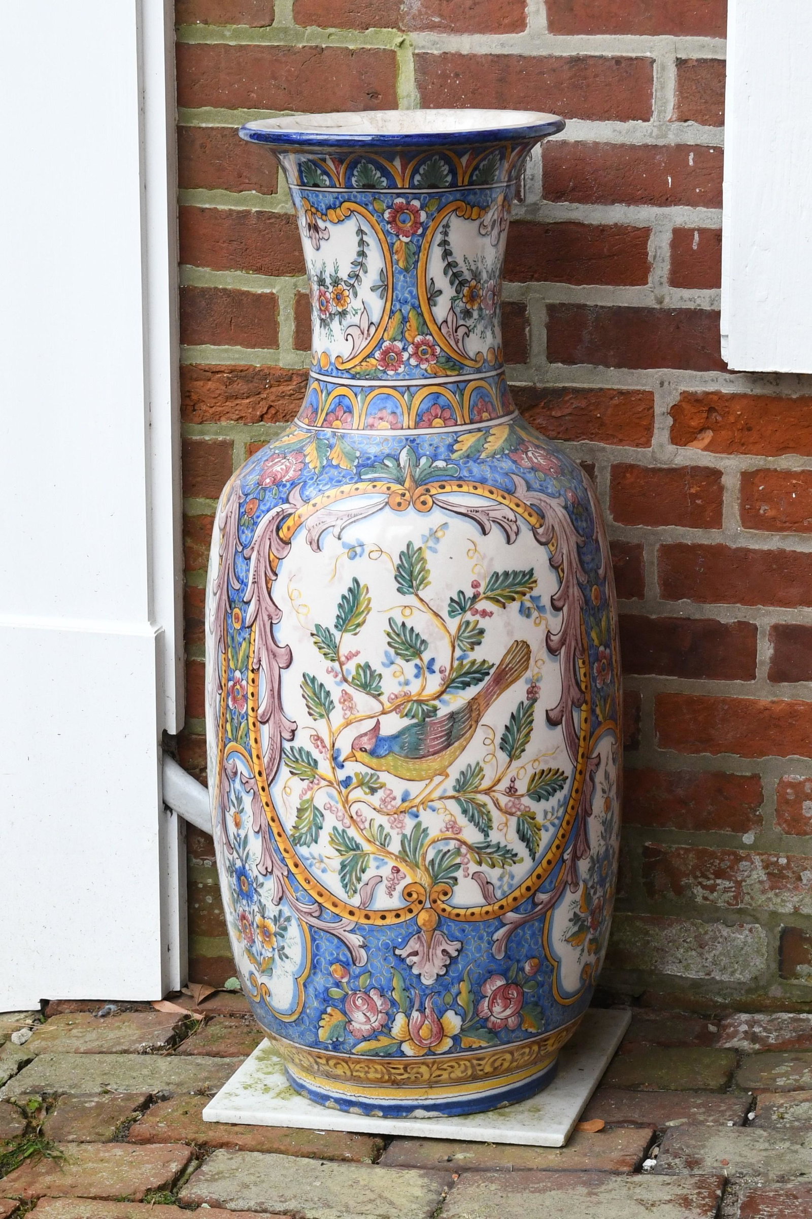 Italian Majolica Glazed Earthenware Vase: An Italian majolica glazed earthenware vase, 20th century, decorated with foliate scrolls, flora and fauna. Dimensions:Height 32in; diameter 15in. IMPORTANT NOTE: ALL preview and pickups for this sale
