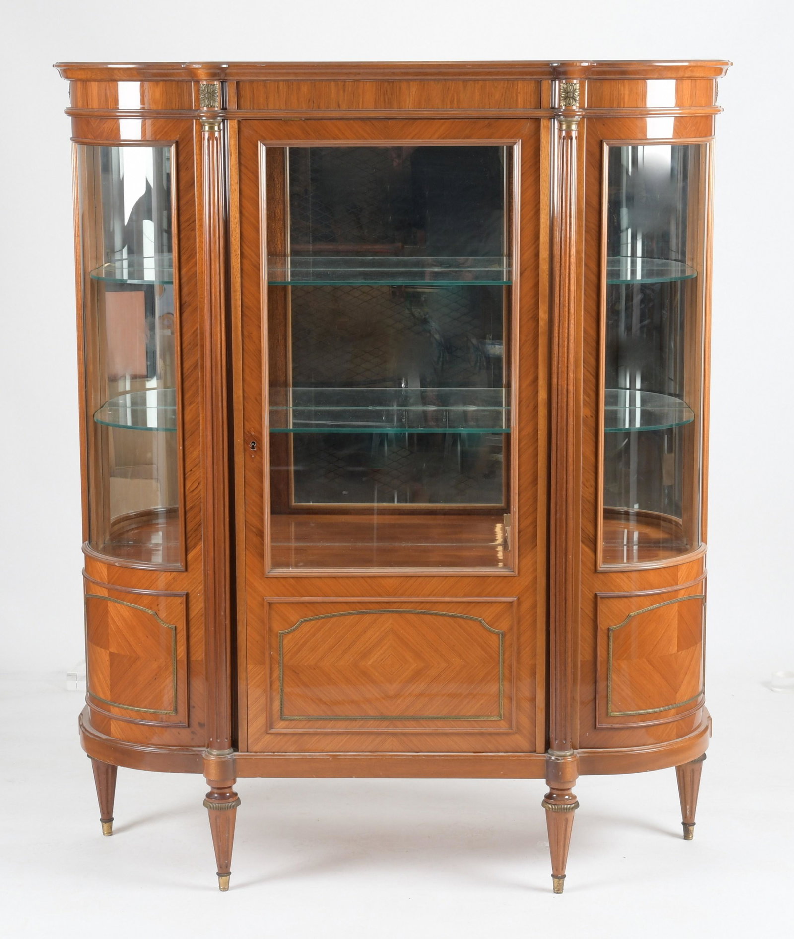 Louis XVI Style Gilt Bronze Mounted Vitrine: A Louis XV style gilt bronze mounted kingwood vitrine, 20th century, having a mirrored back with an adjustable shelved interior. Dimension:Height 68in; width 56 1/4in; depth 17 1/2in.