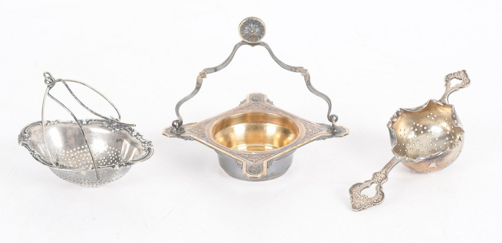 Three Silver Strainers: A sterling example by Gorham, an .800 silver example and a French silver example with a bail handle. Dimensions:From 3" x 2 1/4" to 4 1/2" x 4". The total approximate weight is 3.2 troy ounces. Proven