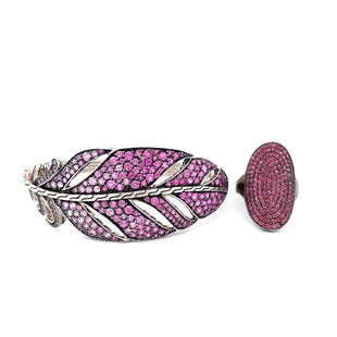 John Hardy Sterling, Pink Sapphire Bracelet and Ring: A signed John Hardy sterling silver feather cuff bracelet with pave pink sapphires and an unsigned darkened sterling silver ring with pink stones.Dimensions:The ring is size 7, the bracelet is 6.5" x