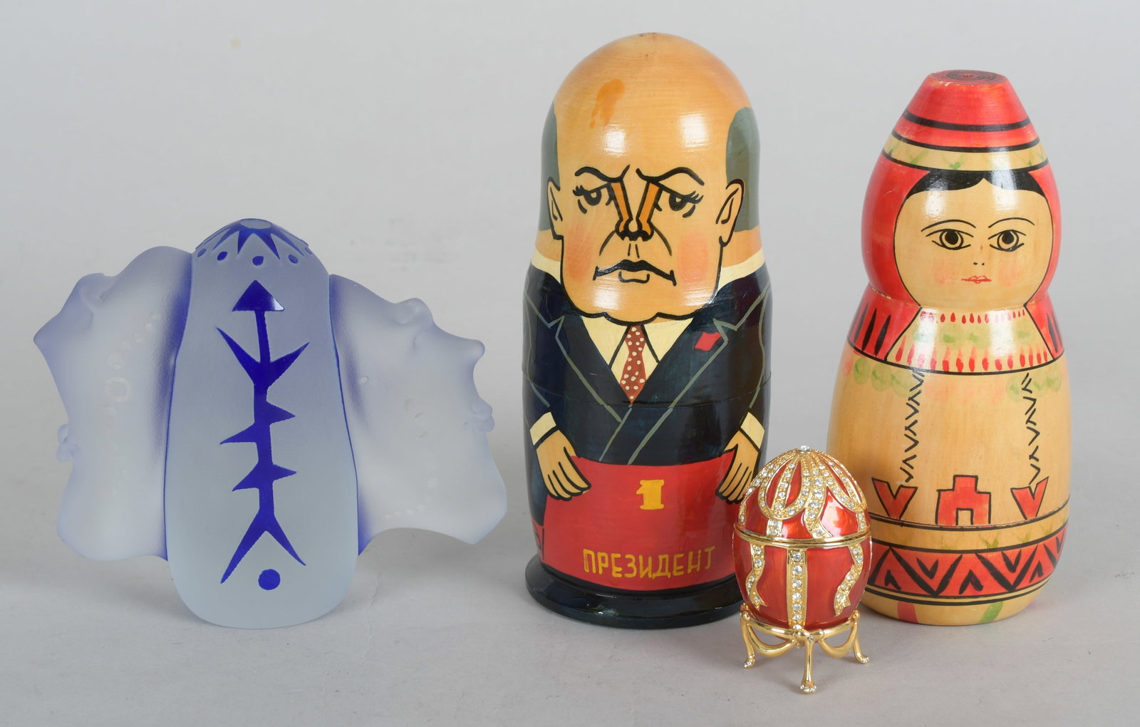 Estate Lot, Russian Nesting Dolls, Glass, Etc...: Comprising: two Soviet era painted wood nesting dolls, an enameled egg form box and an art glass piece by Fellerman & Raabe. Dimensions: From 1 1/2" in diameter to 6" x 3", the