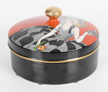 An Art Deco Period Noritake Porcelain Box: An Art Deco period example with figural decoration at the lid, marked as pictured. Dimensions: 7" in diameter, the height is 5".