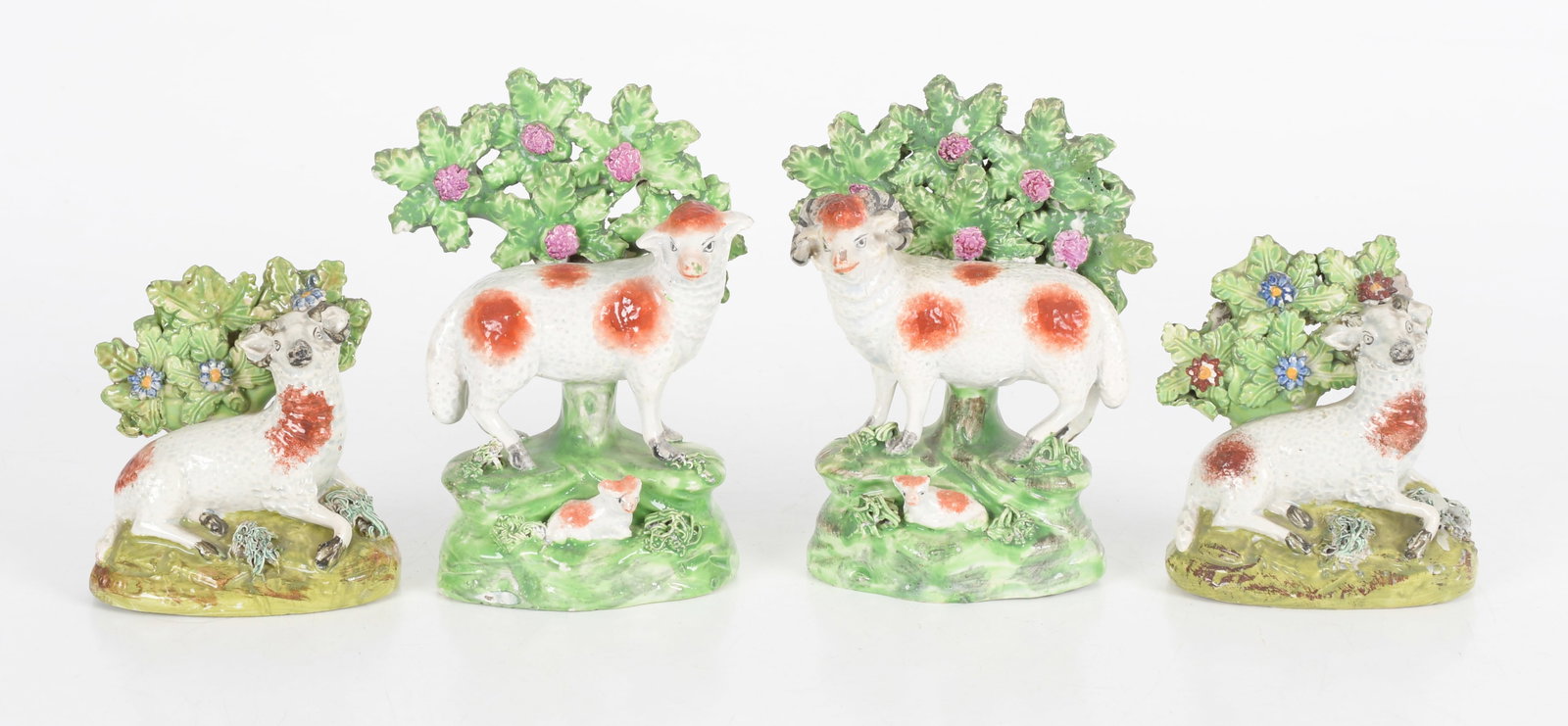 Four Staffordshire Pearlware Bocage Sheep: A Pair of Staffordshire Pearlware Bocage Sheep, First Quarter 19th Century. One figure with a label to the underside for 'Wynn A. Sayman, Richmond, Mass'. Together with two similar sheep group
