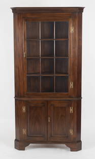 Chippendale Style Mahogany Corner Cupboard: A Chippendale Style Mahogany One-Part Corner Cupboard by Henkel-Harris, Mid 20th Century. The molded cornice above a twelve light single door enclosing a shelved interior, over a pair of raised panele