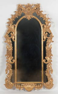 Regence Style Carved Giltwood Mirror: A Regence Style Carved Giltwood Mirror, 20th Century. The crest with carved basket and foliates centered by a large sunflower. Dimensions: Height 62in; width 35in; depth 2in.