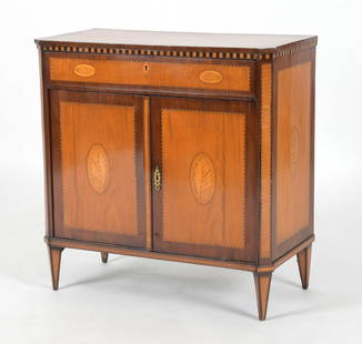 Dutch Neoclassical Inlaid Mahogany Side Cupboard: A Dutch Neoclassical Marquetry Inlaid Fruitwood and Mahogany Side Cupboard, Early 19th Century. The rectangular top with canted corners over a single frieze drawer and pair of cupboard doors below, ra