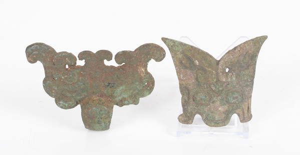 Two Pieces of Chinese Bronze, Han Dynasty: Two Taotie mask examples, a buckle and a handle meant to hold a ring (missing). both Han Dynasty. Dimensions:2 3/4" x 2 1/4" and 3 1/2" x 2 1/2".Provenance: From a local