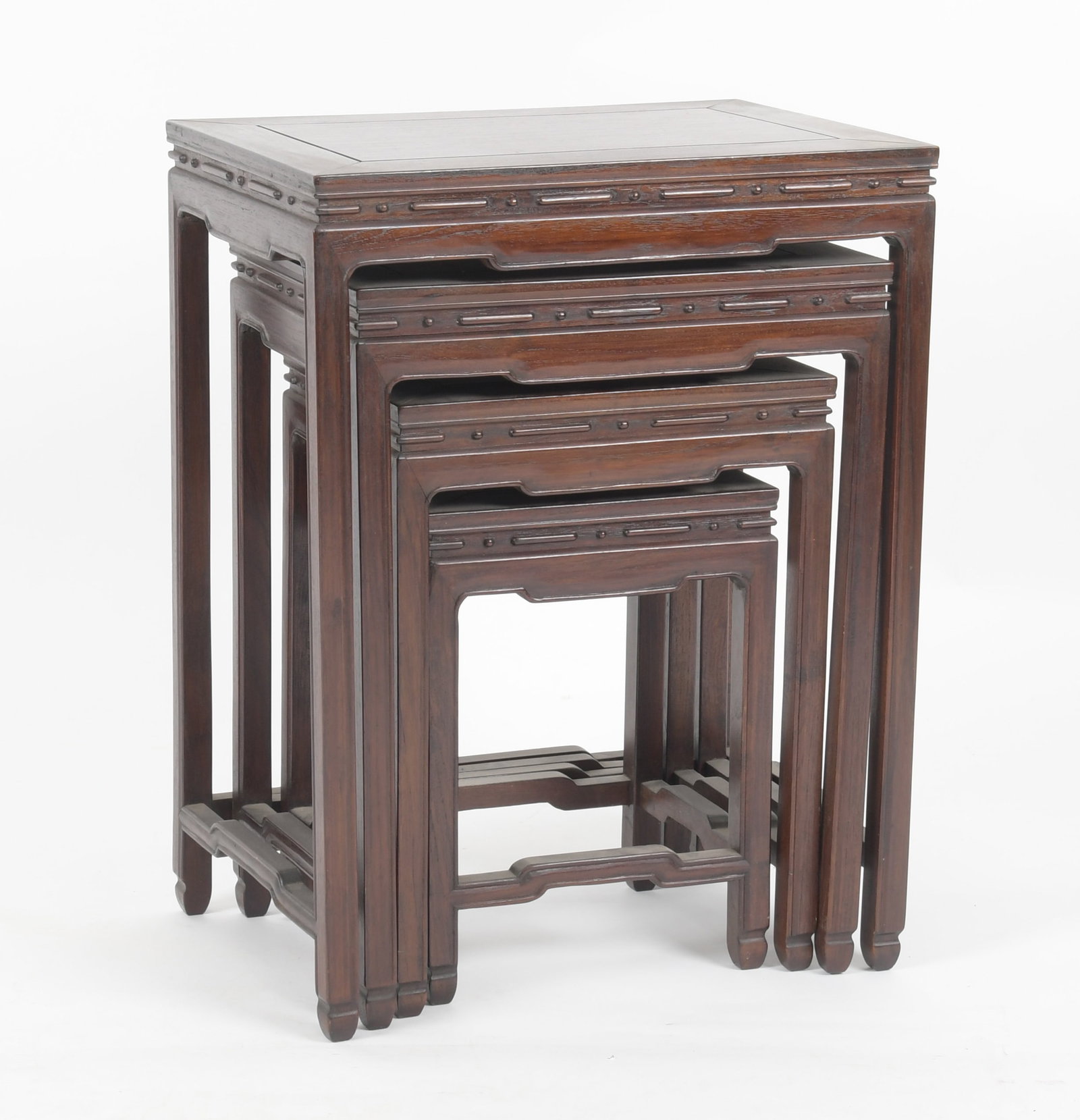 Nest of Four Chinese Carved Hardwood Tables: A Nest of Four Chinese Carved Hardwood Tables, 20th Century. Dimensions: Height of largest 26in; width 20in; depth 14in. Provenance: Property from a New Jersey Collection.