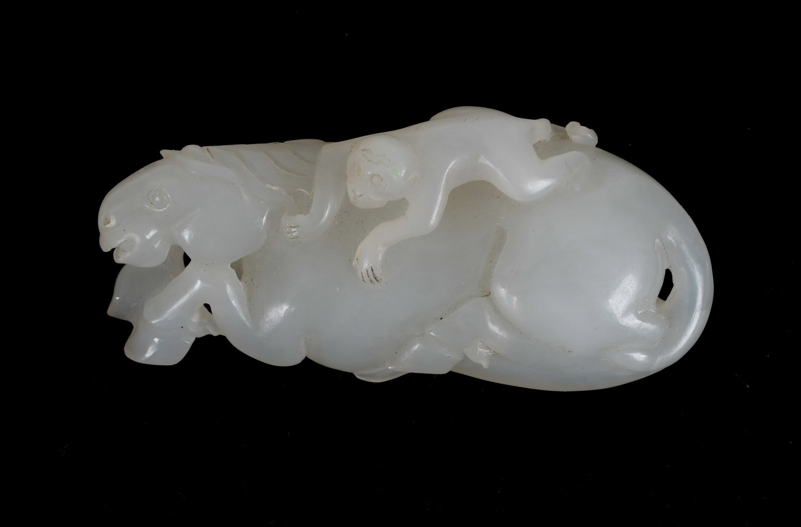 A Chinese Jade Carving, Horse with Monkey: A Chinese white jade carving of a monkey riding a horse. Dimensions: 2 3/4" long. 