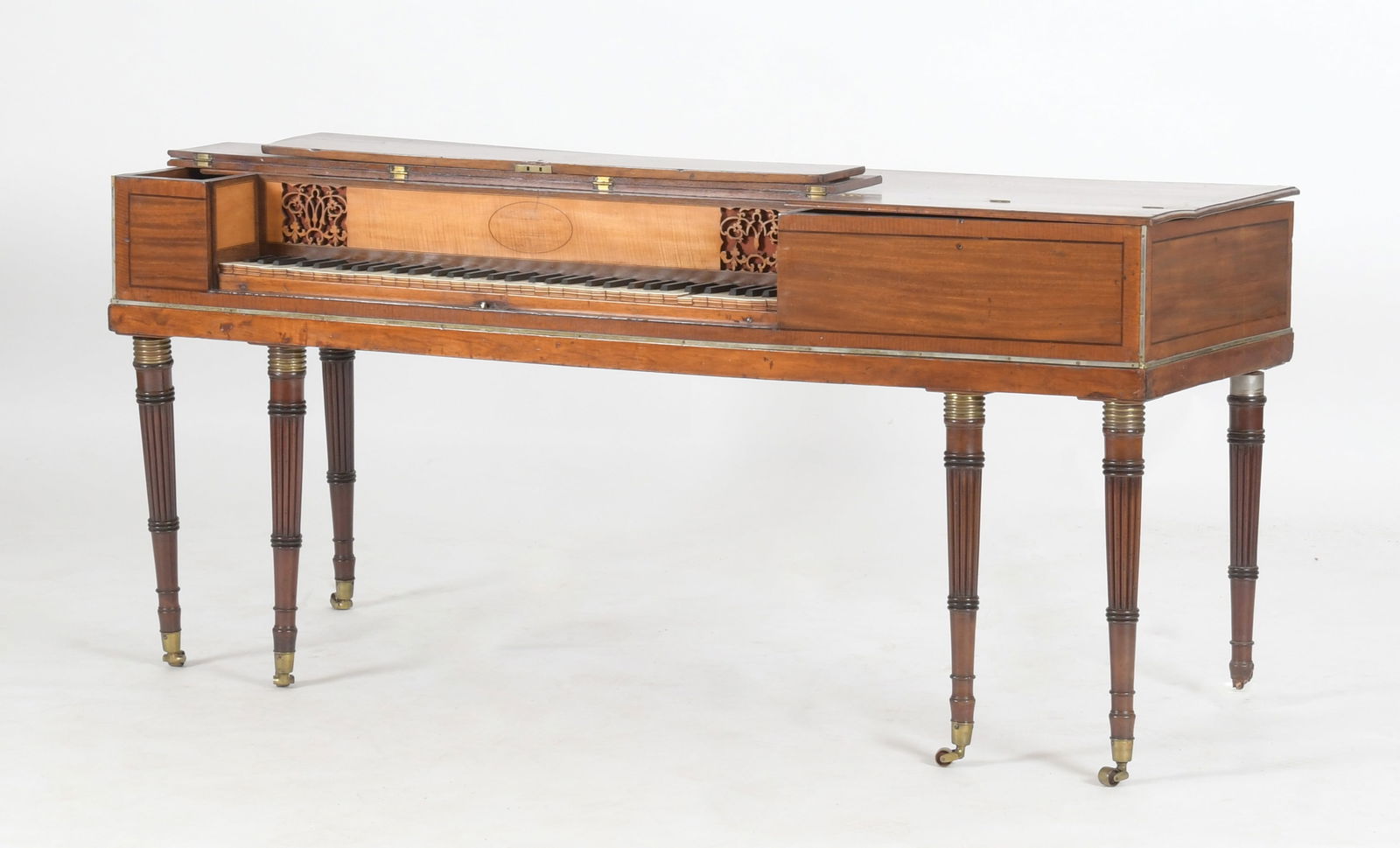 George III Mahogany Square Piano, John Broadwood & Sons, London: A George III Mahogany and Satinwood Square Piano, John Broadwood & Sons, London, Circa 1807. The square case with hinged lid enclosing a sixty-eight keyboard, raised on six ring turned and re