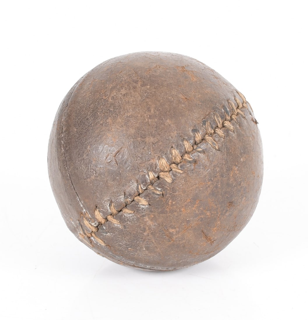 A 19th Century Lemon Peel Leather Baseball: A 19th century four seam baseball with larger stitches to one seam. Dimensions: about 3" in diameter, the weight is 3.8 ounces. 
