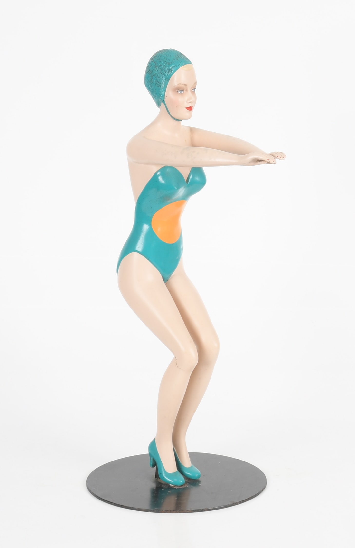 Vintage Towel Holder, Modeled as a Female Swimmer: A Vintage Painted Composition Butler Tray / Towel Holder, Modeled as a Female Swimmer, Mid 20th Century. Mounted to a circular iron base. Dimensions: Height 29 1/2in; width 5 1/2in; depth 13 1/2i