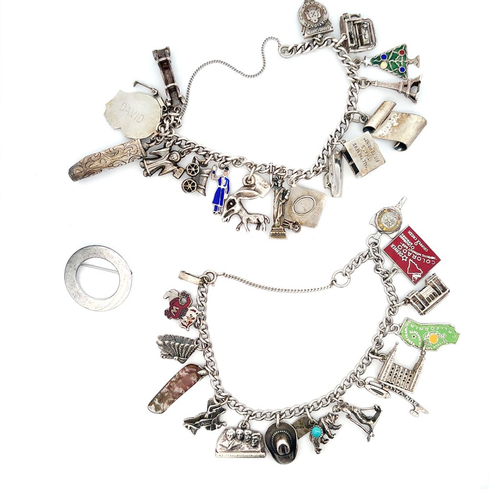 Two Vintage Sterling Silver Charm Bracelets and Pin: Three-piece lot includes a sterling silver circle pin and two sterling silver charm bracelets with a total of thirty charms. Hallmark: Sterling Gross Weight: 55.9dwt / 87.0grams 