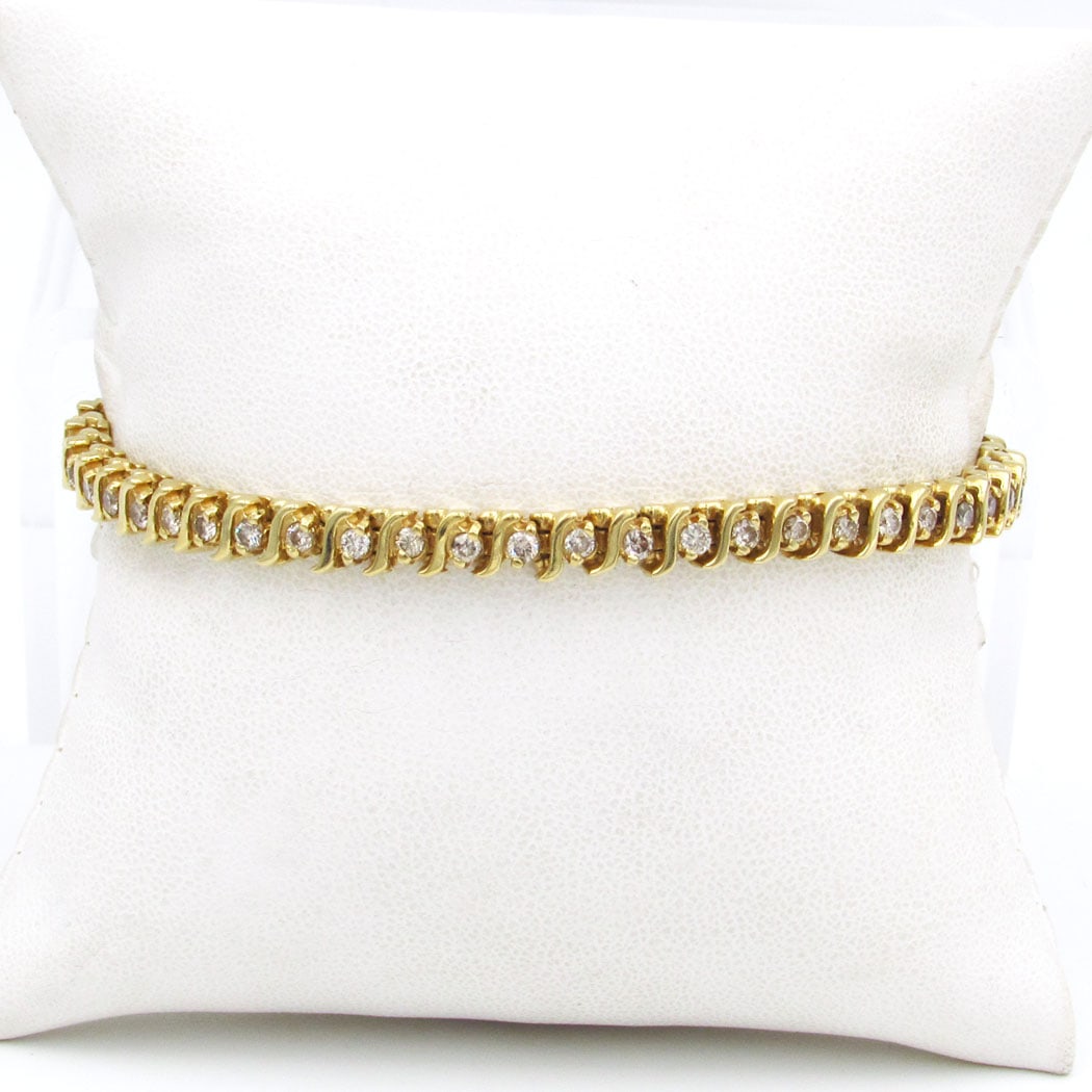 14K Yellow Gold 1.50ct Diamond Tennis Bracelet: 14K yellow gold tennis bracelet. Measures: 7 in Width: ¼ in Hallmark: 14K Diamond: 1.50ct t.w. Gross Weight: 11.1 dwt / 17.3 grams 