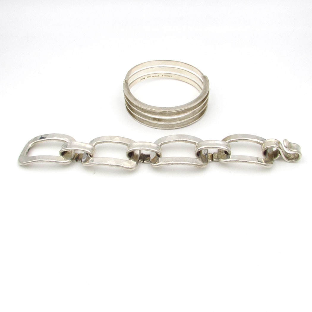 Denmark Sterling Silver E. Ingomar V and J. Hull signed Bracelets: Two signed sterling silver bracelets from Denmark artists Jacob Hull and Erik Ingomar Vangsgaard. The link bracelet is signed Jacob Hull, measures 8” Length x just over 1inch wide. The spiral ba