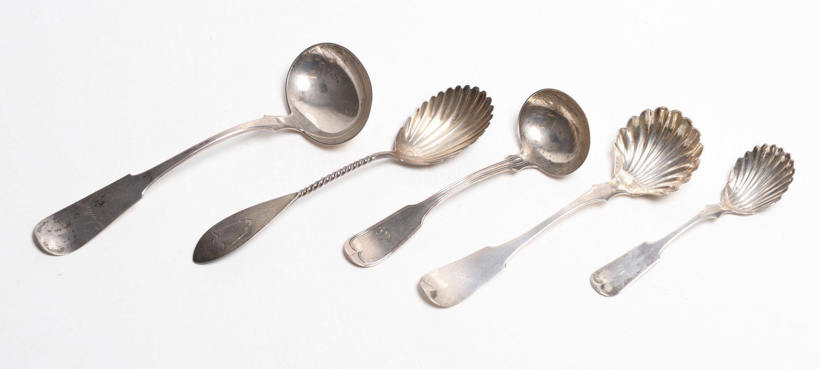 A Group of American Coin Silver Serving Pieces: Comprising: a ladle and shell bowl serving piece by George Russell , a sugar shell by R & W Wilson, sauce ladle by Farr and Thompson, and a shell bowl serving spoon by George Sharp for Bailey and