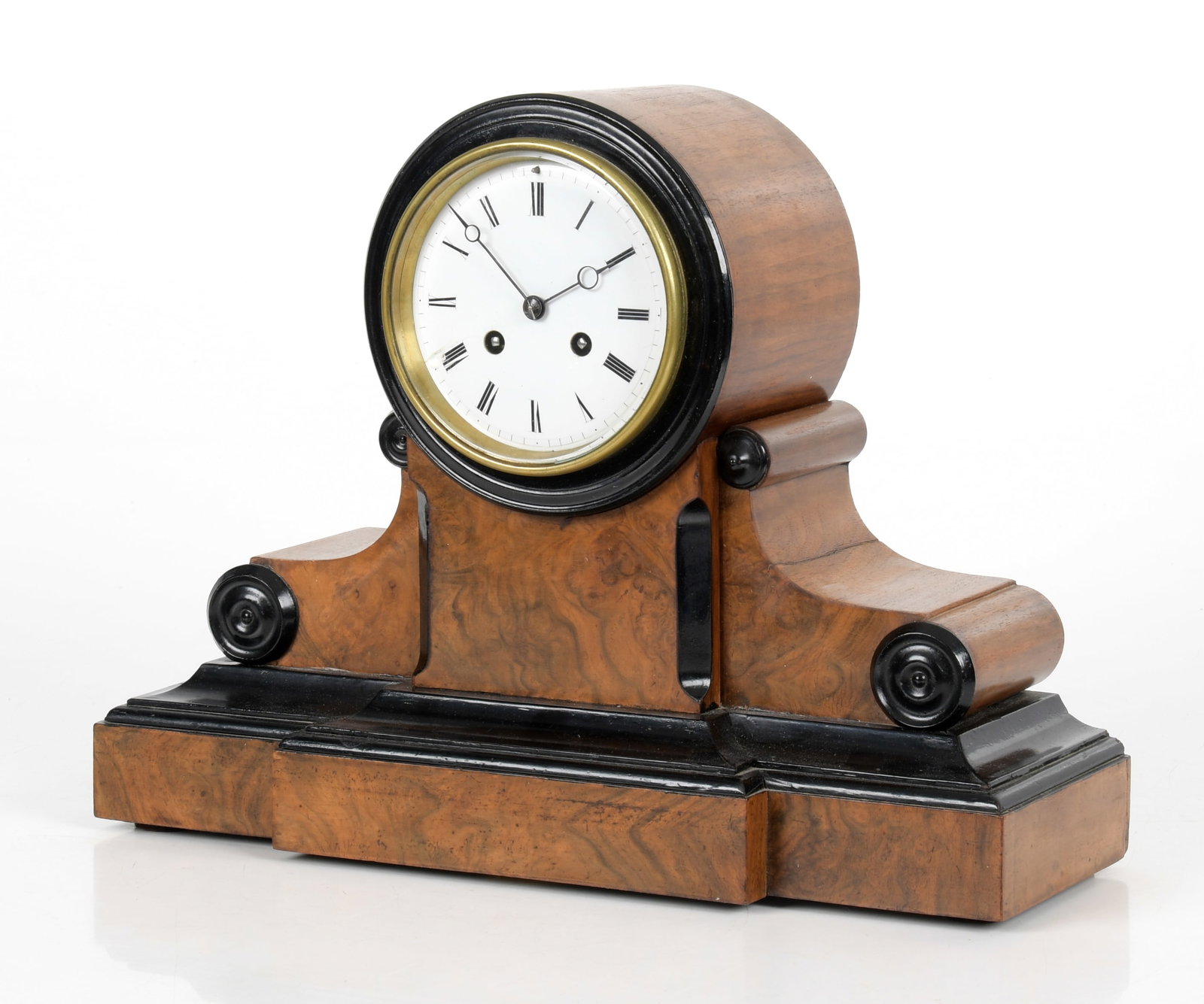 Biedermeier Parcel Ebonized and Figured Walnut Mantel Clock: A Biedermeier Parcel Ebonized and Figured Walnut Mantel Clock, Second Quarter 19th Century. Having a circular enameled dial having Roman numerals, the twin train movement with outside countwheel 