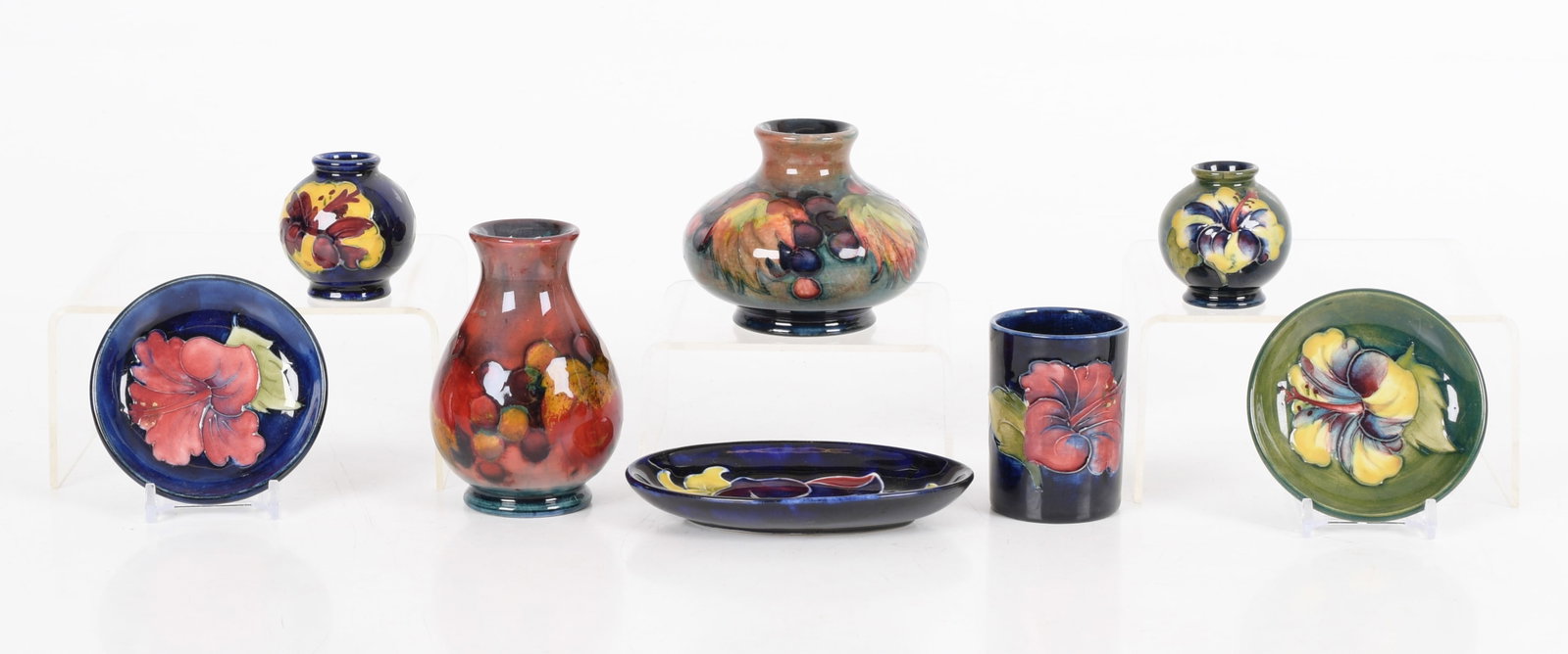 Moorcroft Pottery, Miniature Items: all c. 1920's to mid 20th century, eight miniature pieces, comprising: a vase with leaf and berries under a flambe glaze with William Moorcroft royal mark, a leaf and berries vase with a mott