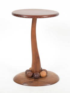 Steven Spiro (20/21st century) Hardwood Table: A candlestand size example with oval base and top, mounted organic egg-like forms at the base and a curved shaft. The top has inlay at the edges. Signed and dated for 1985. Dimension