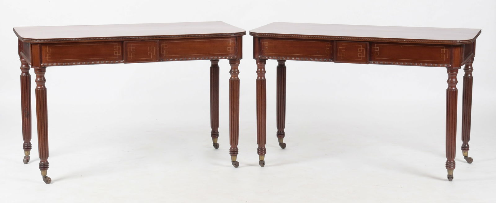 Pair of William IV Inlaid and Carved Mahogany Console Tables: A Pair of William IV Inlaid and Carved Mahogany Console Tables, Second Quarter 19th Century. The 'D' ends of an extension dining table, each having rectangular tops and rounded front