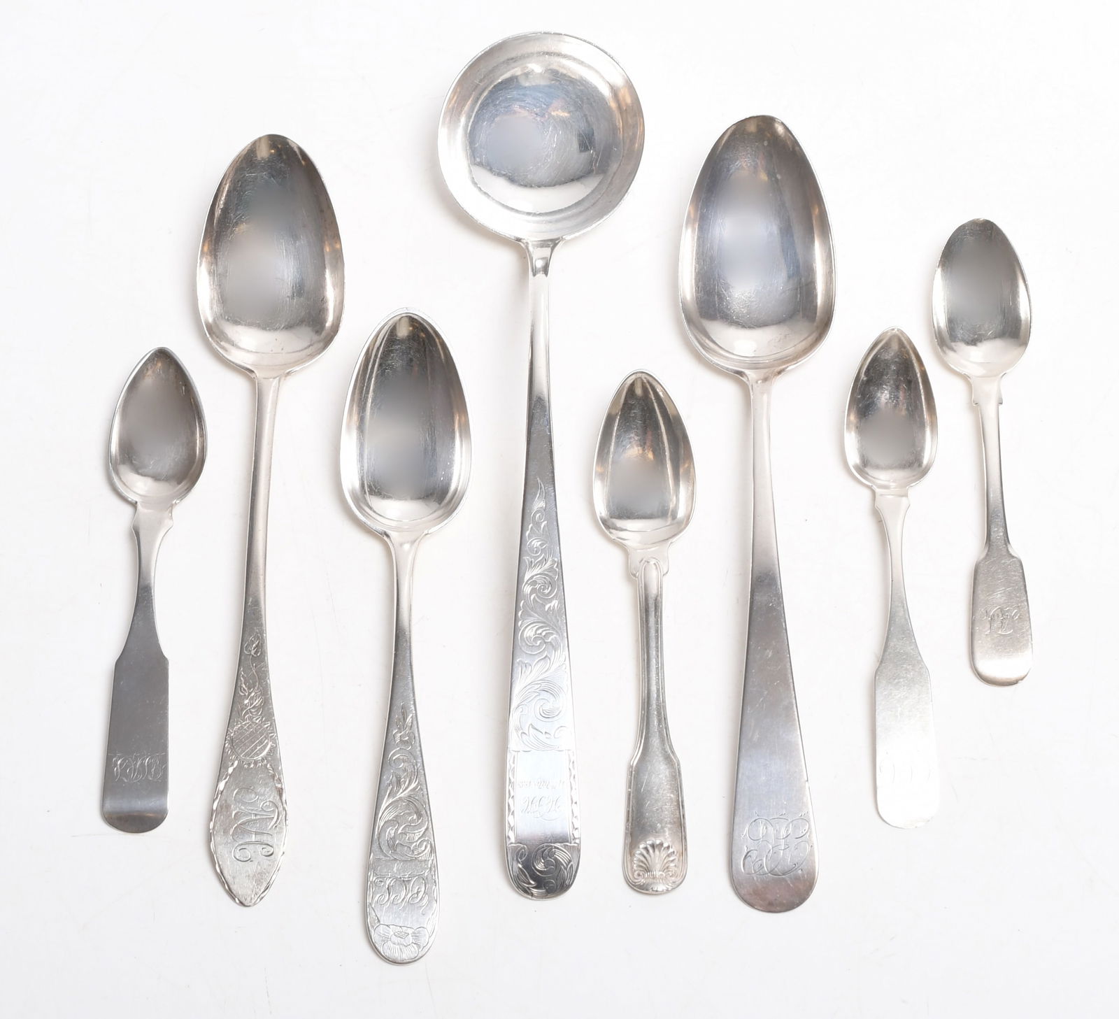 A Group of Baltimore Coin Silver Flatware: Eight total pieces, comprising: a 10" ladle by Samuel Kirk and Son dated for 1858, a 7 1/4" spoon by Andrew Ellicott Warner c. 1805 -70, a 5 1/2" spoon by Robert Brown c. 1830, a 5