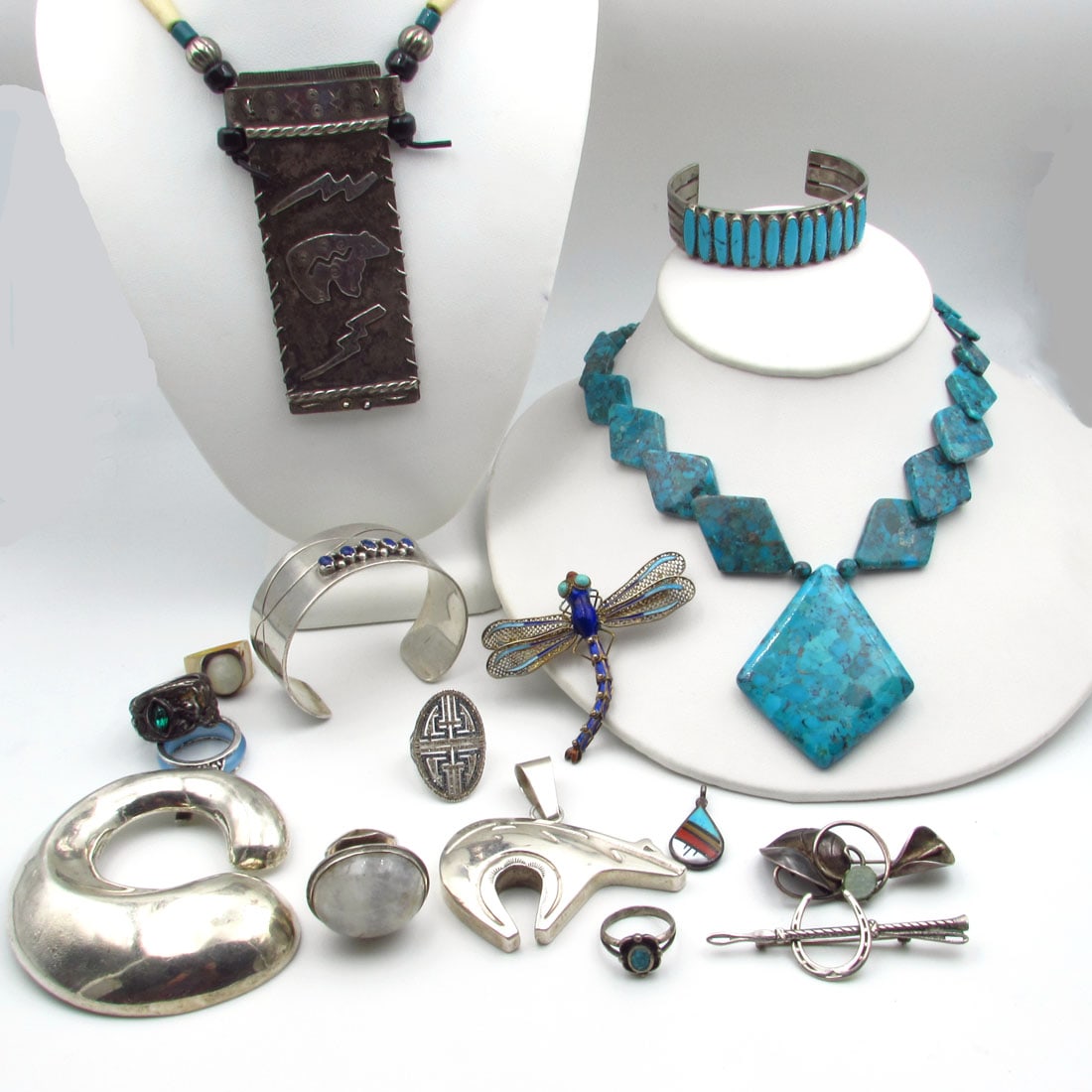 Fifteen piece Native American Sterling Silver Jewelry, Signed: Lot consists of two necklace's, two cuff bracelets, two pendants, three pins, including a chinese dragonfly and six rings, two are not sterling. Many signed pieces. The Gross weight of sterling si