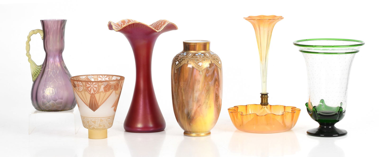 A Group of European Art Glass: A Group of European Art Glass. Comprising: An iridescent pale orange trumpet form vase with attached bowl, a Loetz type purple and green ewer, a ruby colored stretch vase with flared rim, a marbled gl