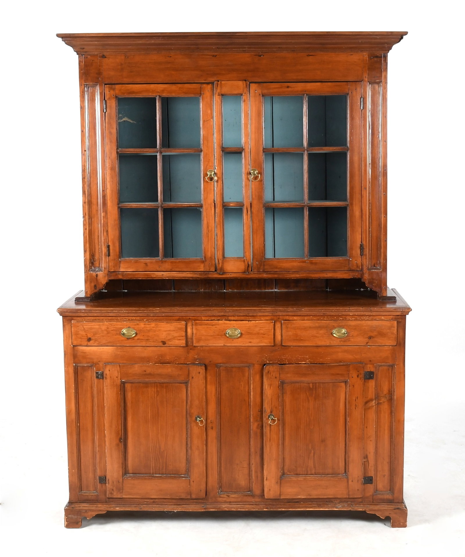 Pennsylvania Chippendale Softwood Two-Part Dutch Cupboard: A Pennsylvania Chippendale Softwood Two-Part Dutch Cupboard, Late 18th / Early 19th Century. The upper section with a molded cornice above a pair of glazed cupboard doors with twelve lights, enclosing