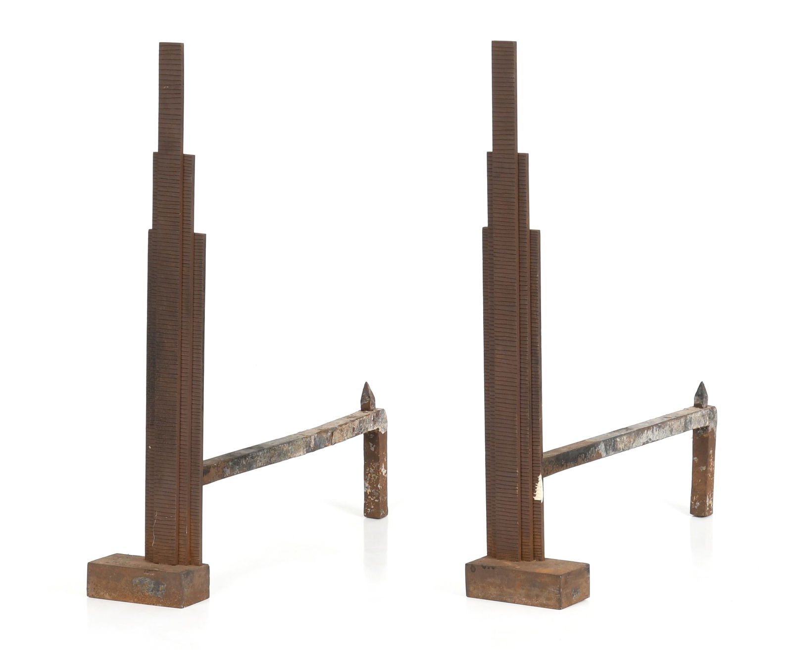 Pair of Art Deco Iron 'Skyscraper' Andirons: A Pair of Art Deco Iron 'Skyscraper' Andirons, Second Quarter 20th Century. The vertical elements with horizontal incising overall. Dimensions: Height 22in; width 4 1/4in; depth 18 3/4in.
