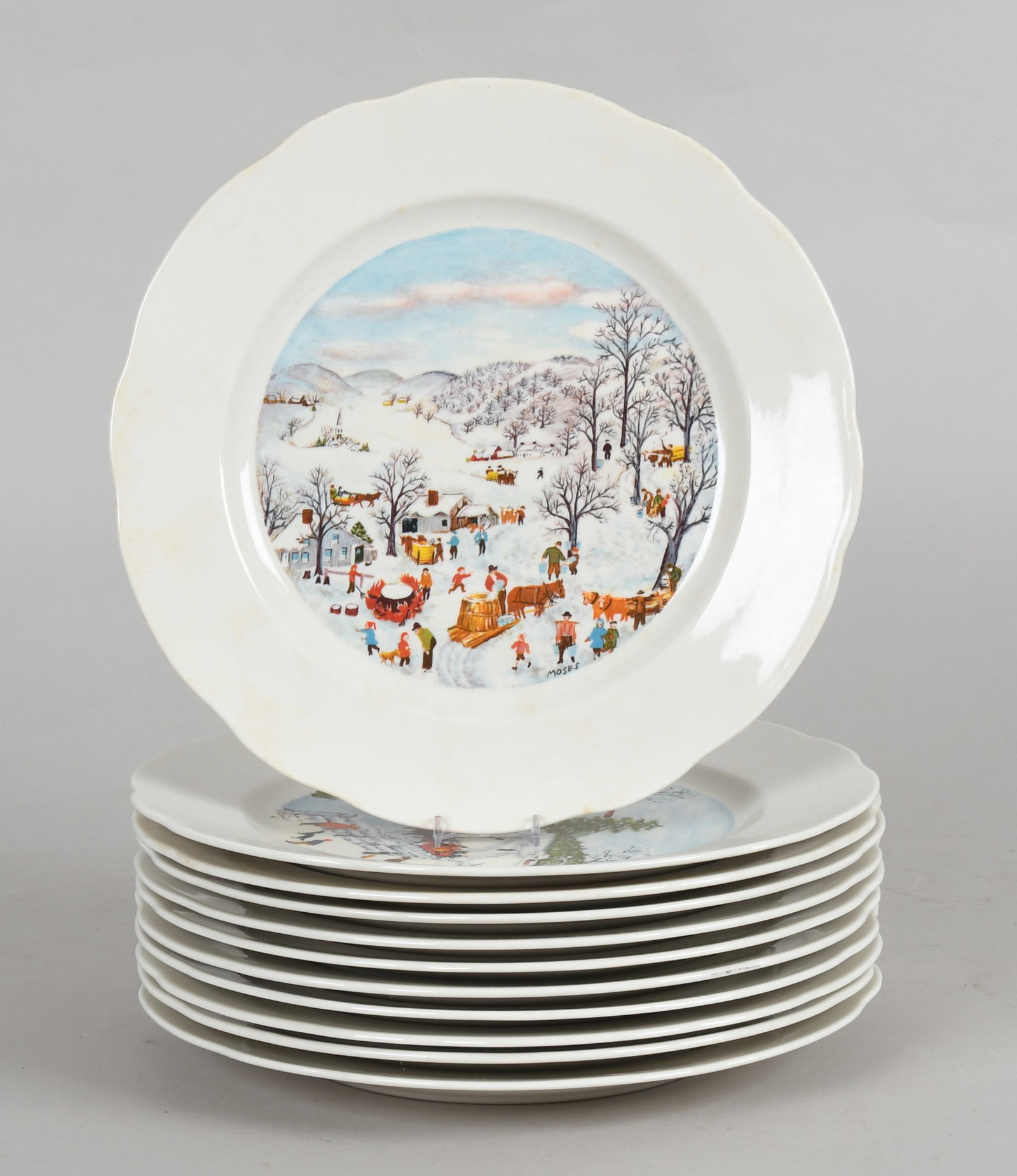 A Set of Porcelain Plates, Grandma Moses Decoration: A Set of Porcelain Plates, Grandma Moses Decoration Circa 1972, by the Syracuse China company, decorated with various artwork. Eleven plates. Dimensions: each has