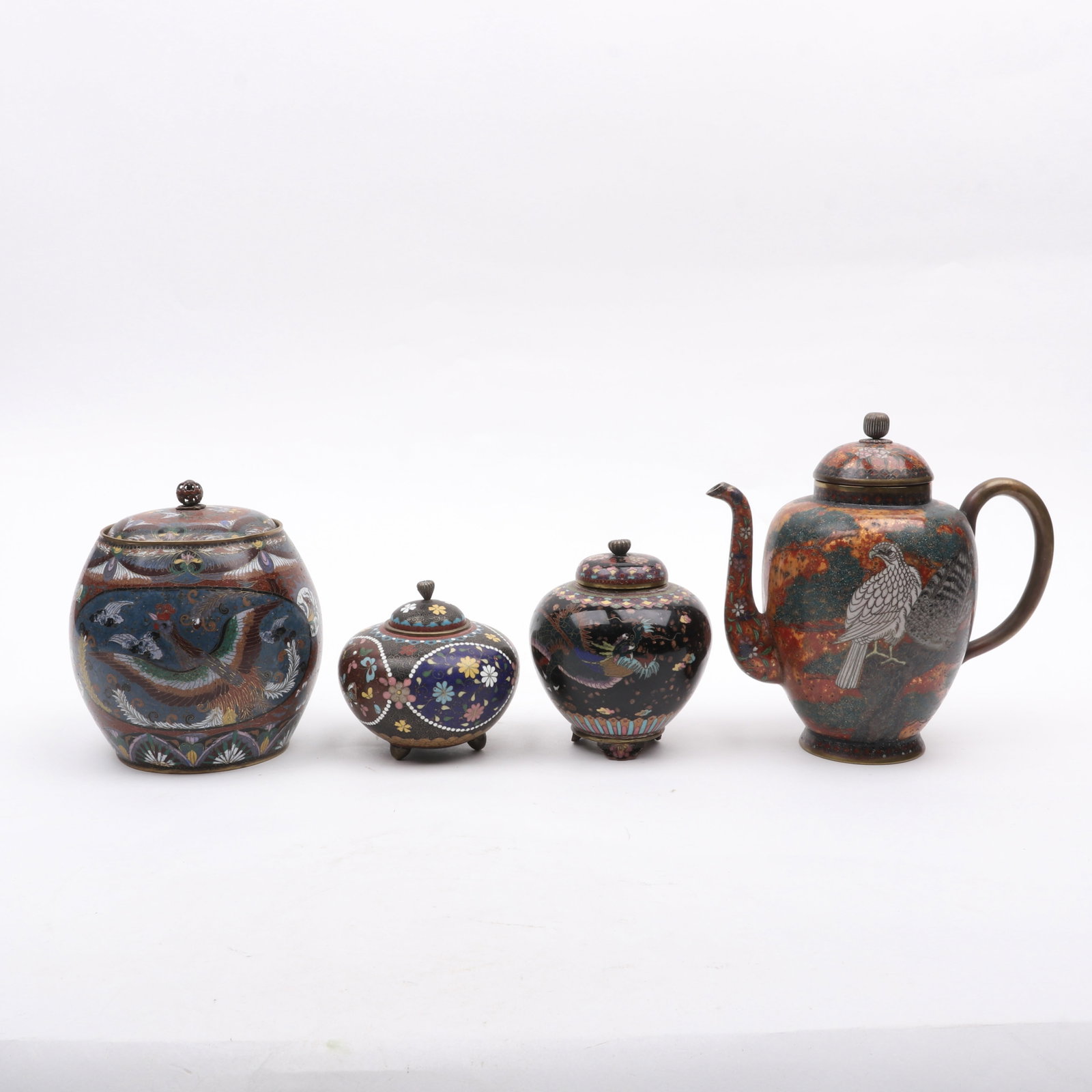 Four Examples of Japanese Cloisonne: Four Examples of Japanese Cloisonne All late 19th century, a bird decorated teapot, a floral and bird decorated koro, a dragon decorated koro with gold flecking and a covered jar with Ho-o Bird 
