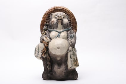 A Large Japanese Pottery Tanuki Figure