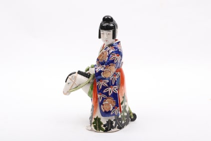 A Japanese Porcelain Kutani Figure, Woman Riding a Hobby Horse