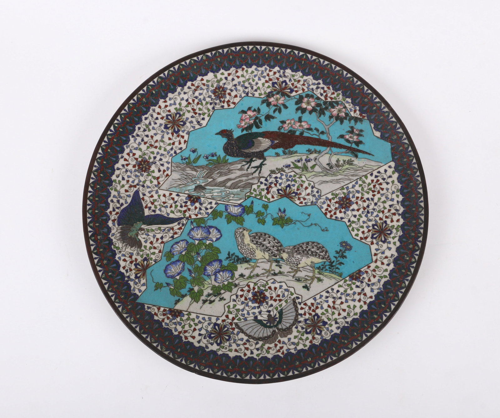 A Japanese Cloisonne Decoration, Bird Decoration: A Japanese Cloisonne Decoration, Bird Decoration With a white ground and decorated with fan shaped panels with birds. Dimensions: 18in diameter. 