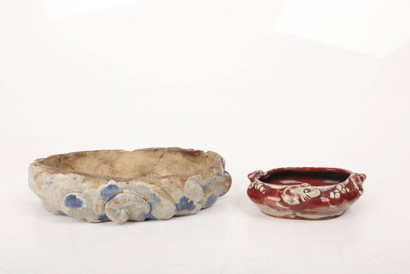 Chinese Pottery, a Bulb Bowl and Brush Washer: Chinese Pottery, a Bulb Bowl and Brush Washer Both Qing Dynasty, a brush washer with applied mouse decoration and an oxblood glaze and a stoneware bulb pot with applied cloud decoration in a blu