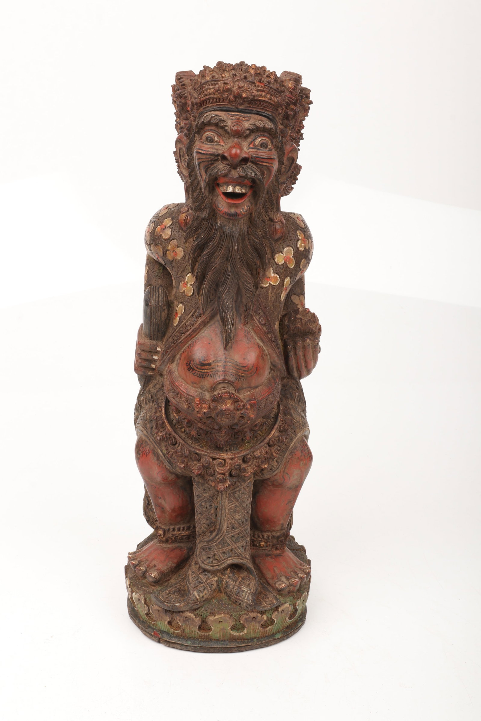 A Balinese Wooden Sculpture of Rangda: A Balinese Wooden Sculpture of Rangda A well detailed carving with polychrome, 20th century or earlier. Dimensions: 6 1/2in diameter, 16in tall. 