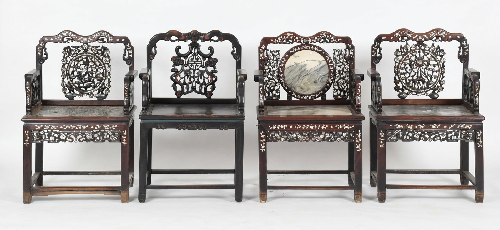 Four Chinese Rosewood Armchairs: A Matched Pair of Chinese Mother-of-Pearl Inlaid Carved Rosewood and Marble Armchairs, Late 19th / Early 20th Century The yoked crest above a pierced splat, flanked by straight stiles and straight&nbs