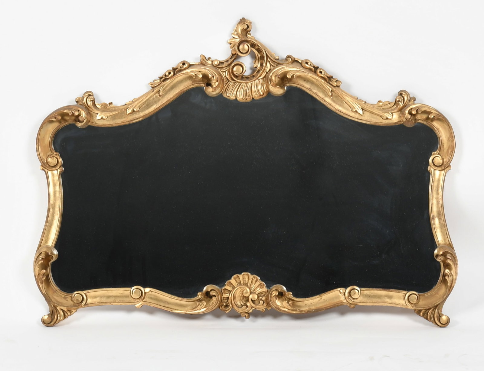 Rococo Carved Giltwood Over Mantel Mirror, First Half 20th Century: A Rococo Carved Giltwood Over Mantel Mirror, First Half 20th Century Decorated with carved foliates and scrolls. Dimensions: Height 30in; width 40in; depth 2 1/2in. Provenance: 