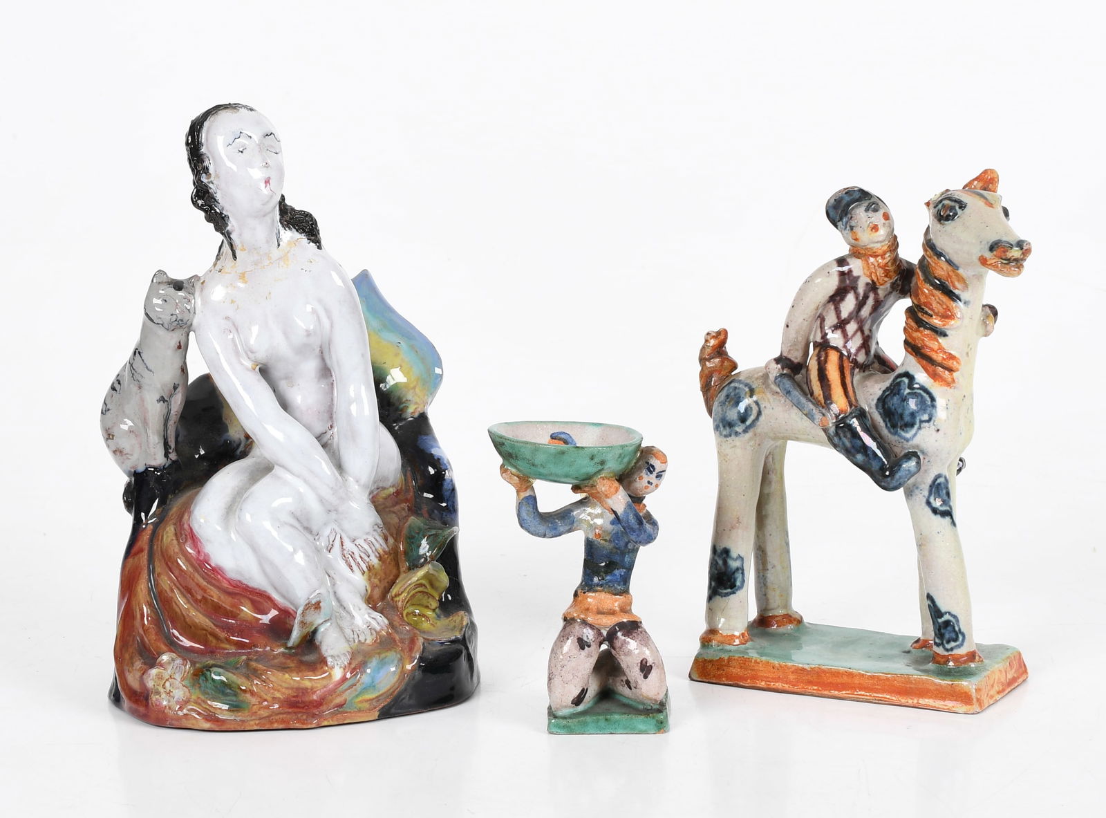 Three Pieces of Wiener Werkstatte Pottery: Three Pieces of Wiener Werkstatte Pottery A jockey and horse group and a small figure both by Gudrun Baudisch and a group with nude figure and cat by Susi Singer, all marked as pictured.&n