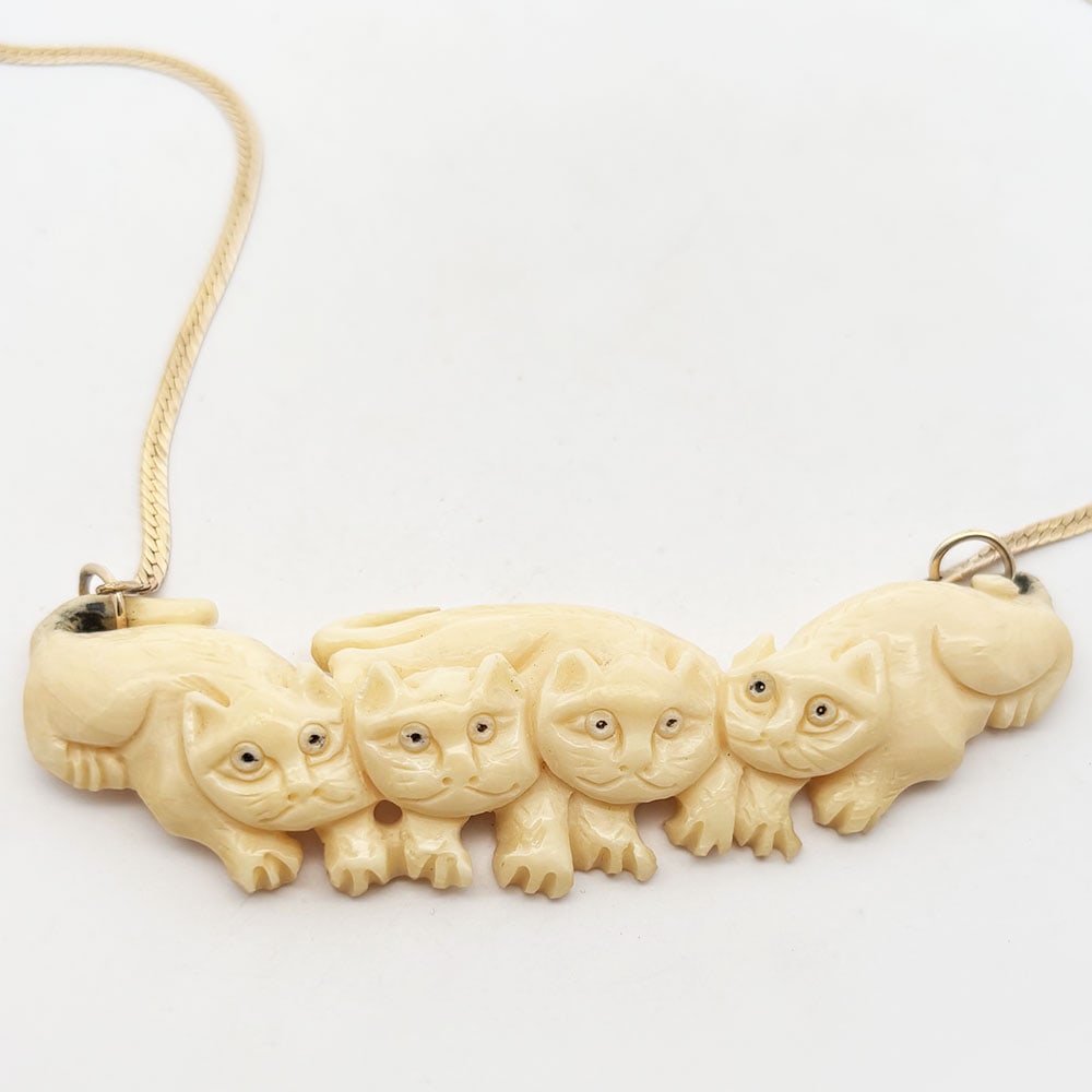 Five piece 14K Herringbone Chain Necklace lot: Five piece lot consists of one necklace with carved bone pendant of four cats, a tri-color gold chain, and three herringbone chains. All marked 14K. Chains measure 16 inch, 18 inches and 24 inches. Ch