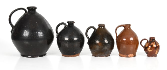 Five American Lead and Manganese Glazed Redware Ovoid Jugs