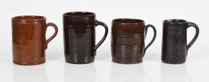 Four American Glazed Redware Tankards/ Mugs, 19th Century