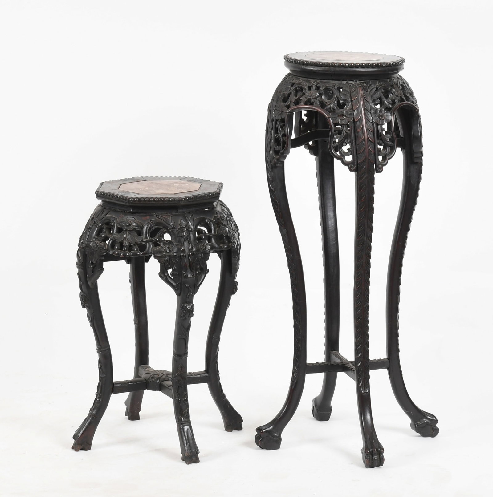 Two Chinese Carved Rosewood Pedestal Stands: Two Chinese Carved Rosewood Pedestal Stands, Late 19th / Early 20th Century Each having an inset marble top, above a profusely carved and pierced frieze and apron, raised on carved cabriole 