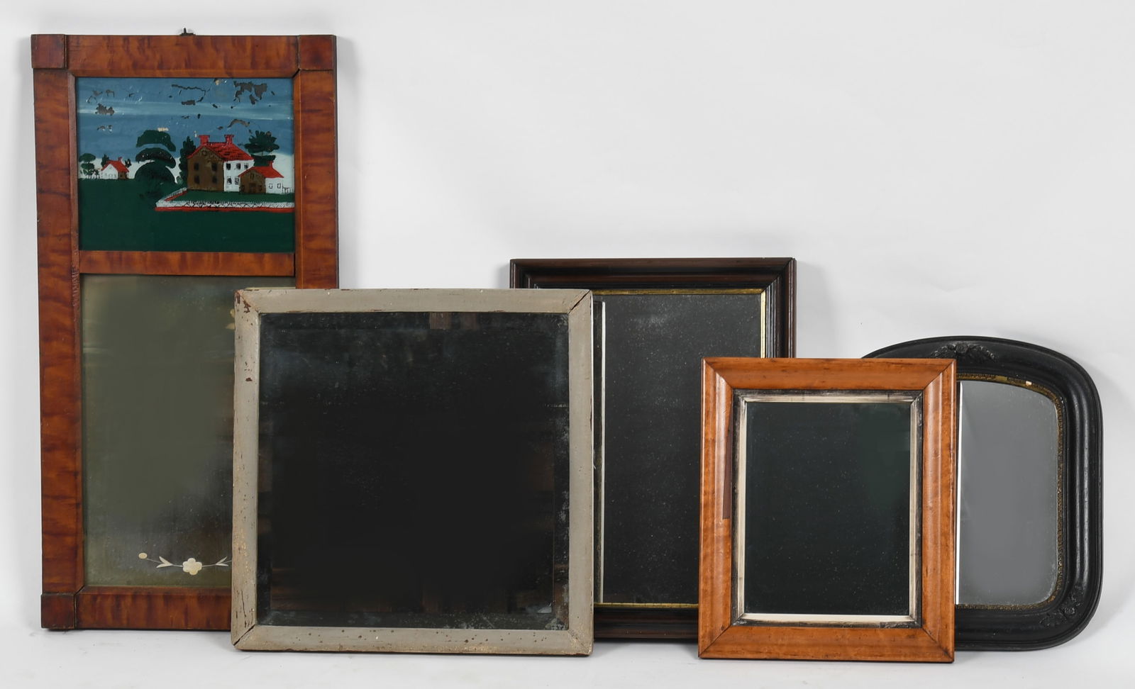 Group of Five Antique Mirrors, 19th Century: A Group of Five Antique Mirrors, 19th Century Comprising a Late Federal faux grained reverse painted on glass mirror; a beige painted mirror with beveled glass plate; a birdseye maple frame; an eboniz