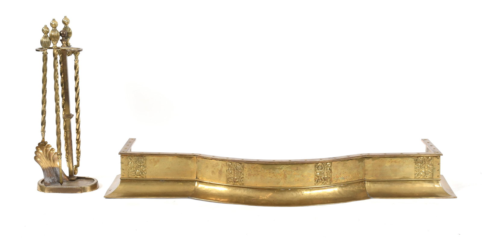 Group of Antique Fireplace Accessories, Late 19th / Early 20th Century: An Art Nouveau Brass Fire Fender, Late 19th / Early 20th Century Together with a brass tongs, poker, shovel and stand. (5) Dimensions: Height of fender 7in; width 57 1/2in; depth 19 1/4in; Height